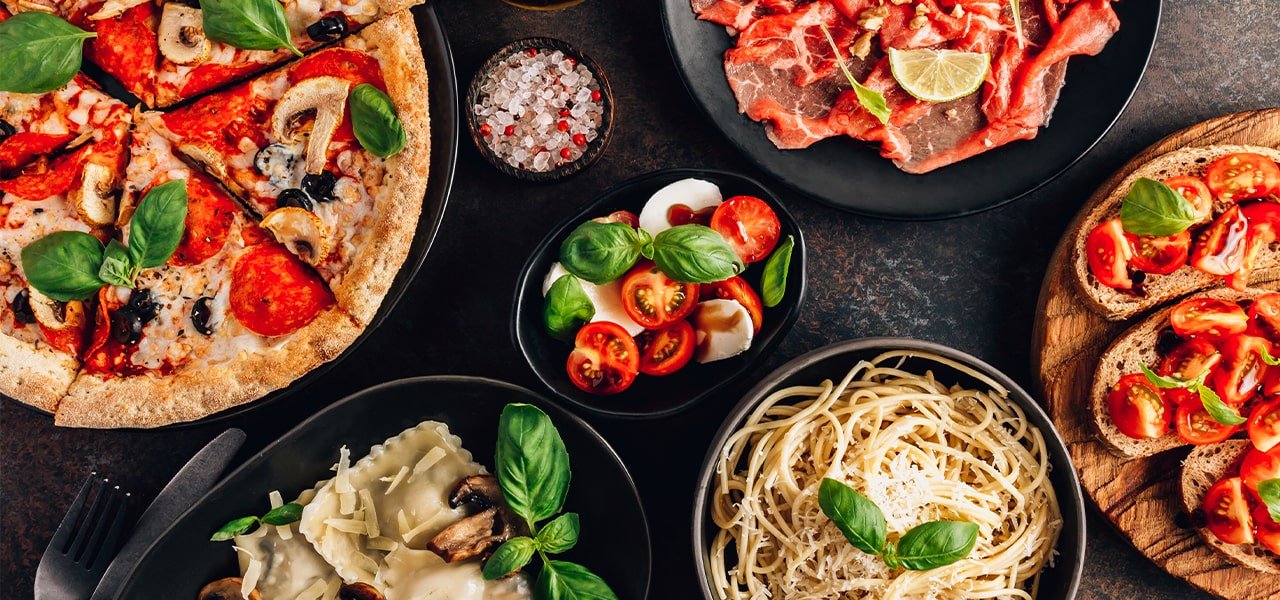 plates of Italian food - pizza, pasta bruchetta